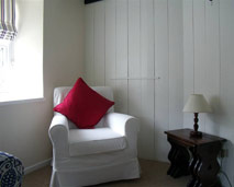 photo of Armchair in corner of lounge in Porth Cottage