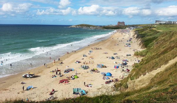 Sunbathers, swimmers and surfers on Fistral beach