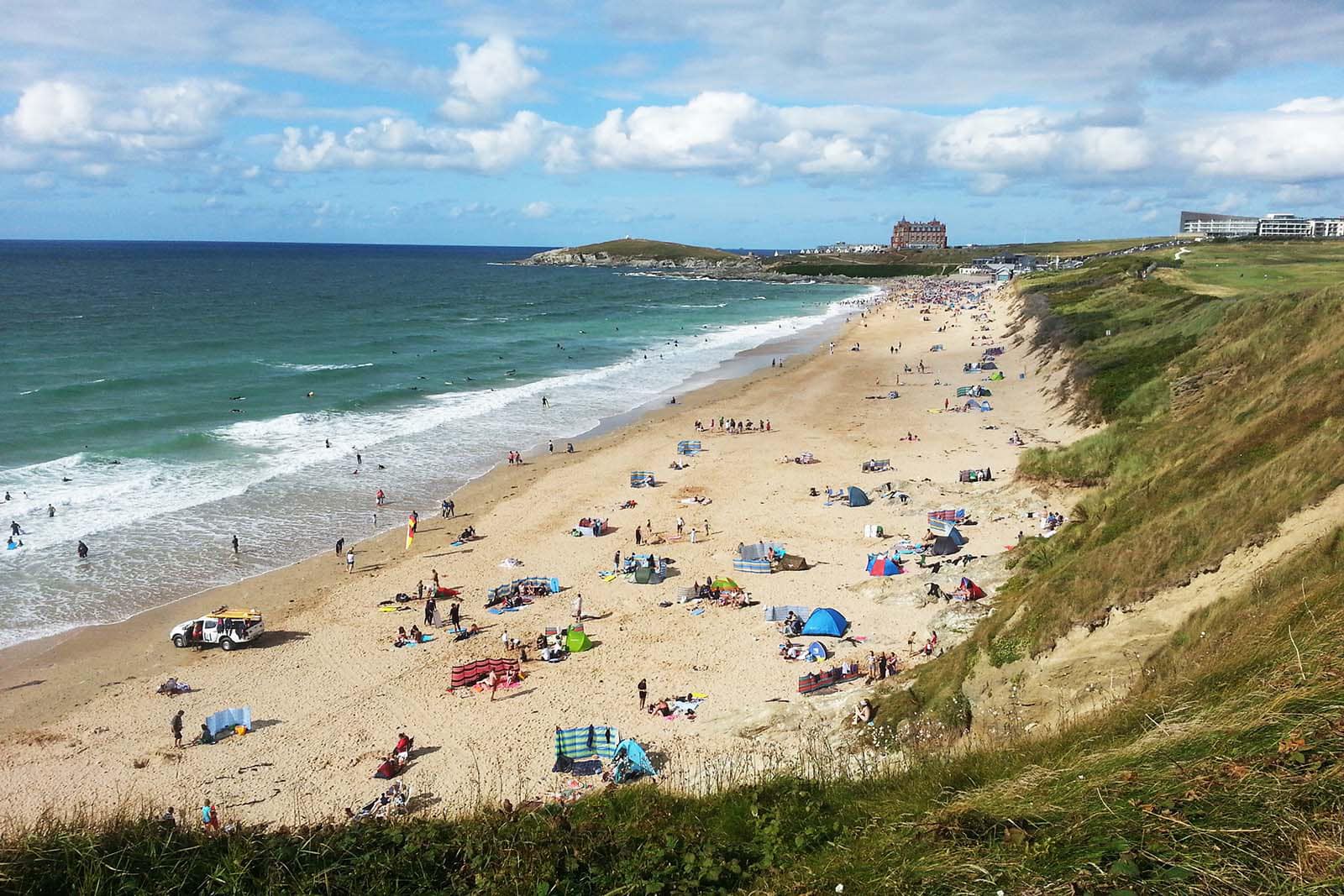 Sunbathers, swimmers and surfers on Fistral beach