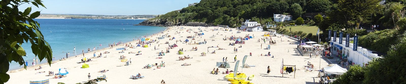 people sunbathing and swimming at Porthminster beach