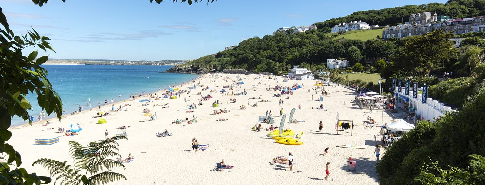 people sunbathing and swimming at Porthminster beach