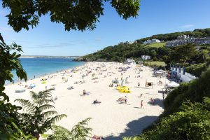 people sunbathing and swimming at Porthminster beach