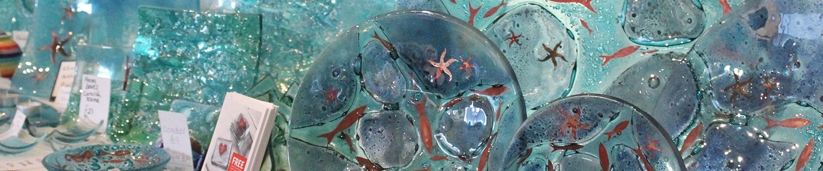 blue glass plates and dishes with fish and starfish patterns on them