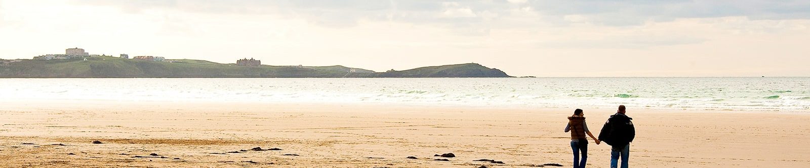 couple walking at Watergate Bay