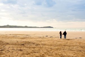 couple walking at Watergate Bay