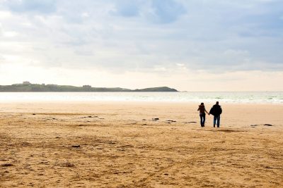 couple walking at Watergate Bay