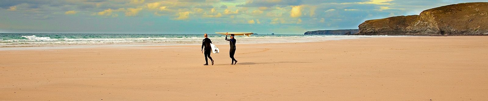 surfers walking to sea