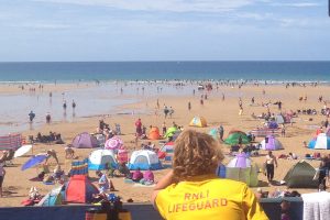 lifeguard watching watergate bay beach