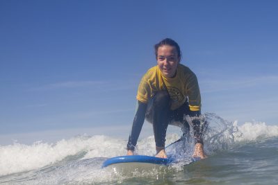 girl kneeling on surf board