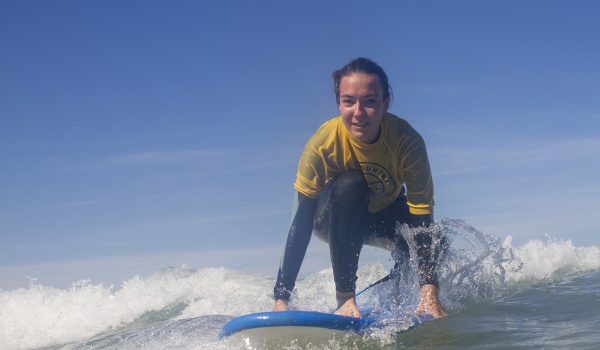 girl kneeling on surf board