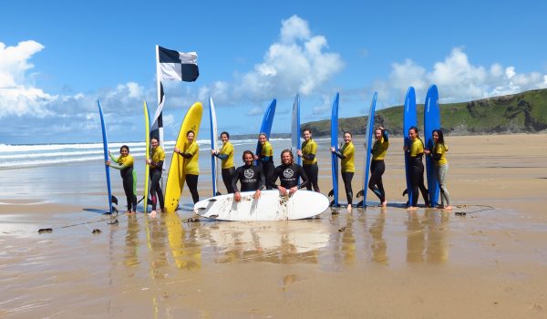 group of surfers on beach