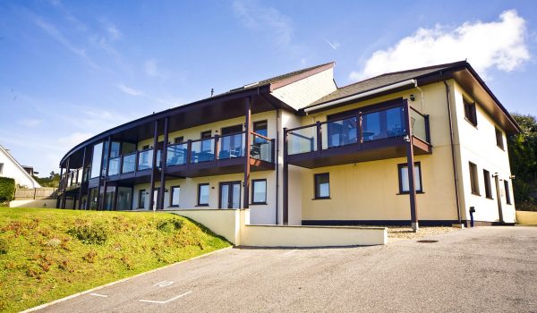 exterior of white lodge apartments