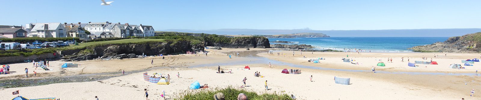 Two people on bench overlooking Trevone beach