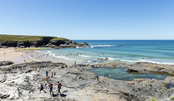 People in the sea and bathing pool at Treyarnon Bay