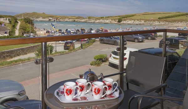 Table set with refreshments overlooking Porth Beach