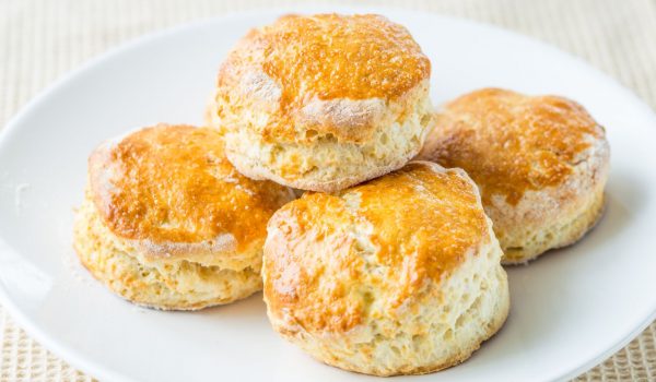 close Up of homemade cheese scones on a white plate