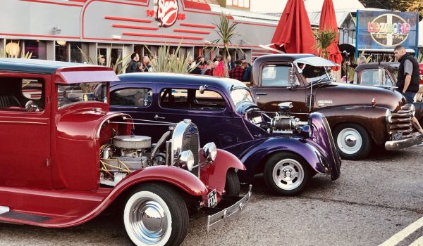 Vintage American cars parked outside of Sam's Diner