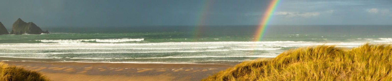 Double rainbow over Holywell bay in winter