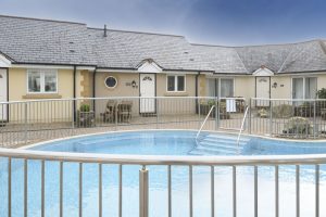 The exterior of the pool view apartments and the pool