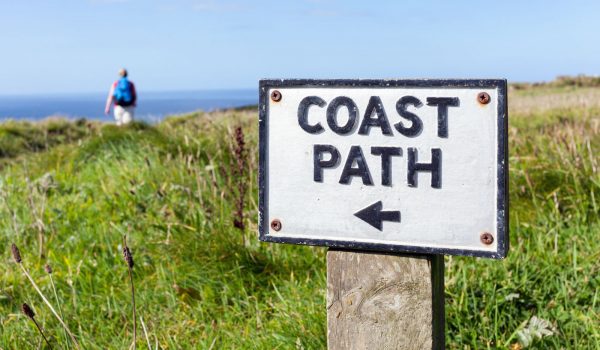 An old coast path sign on the Cornish cliffs near Tintagel