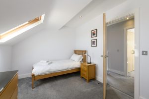 Single bed in twin bedroom