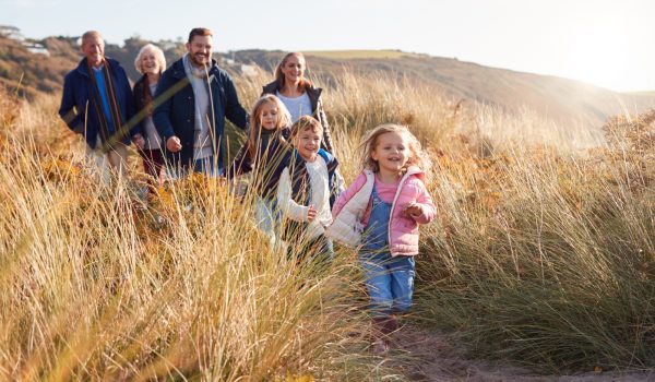 Large family walking through sand dunes