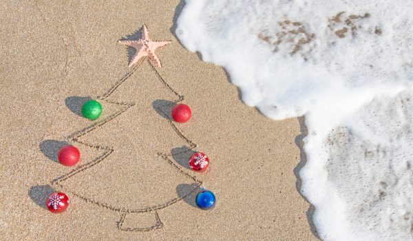 Christmas tree drawn in sand with real baubles