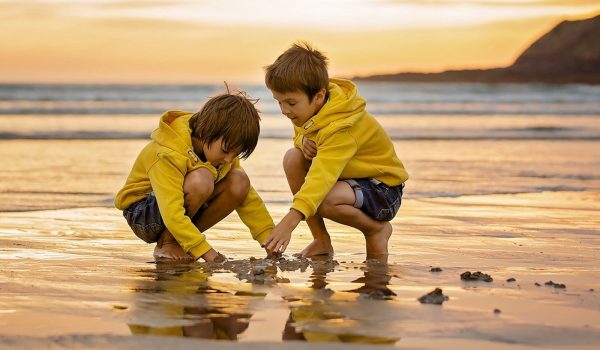 two boys playing in the sand