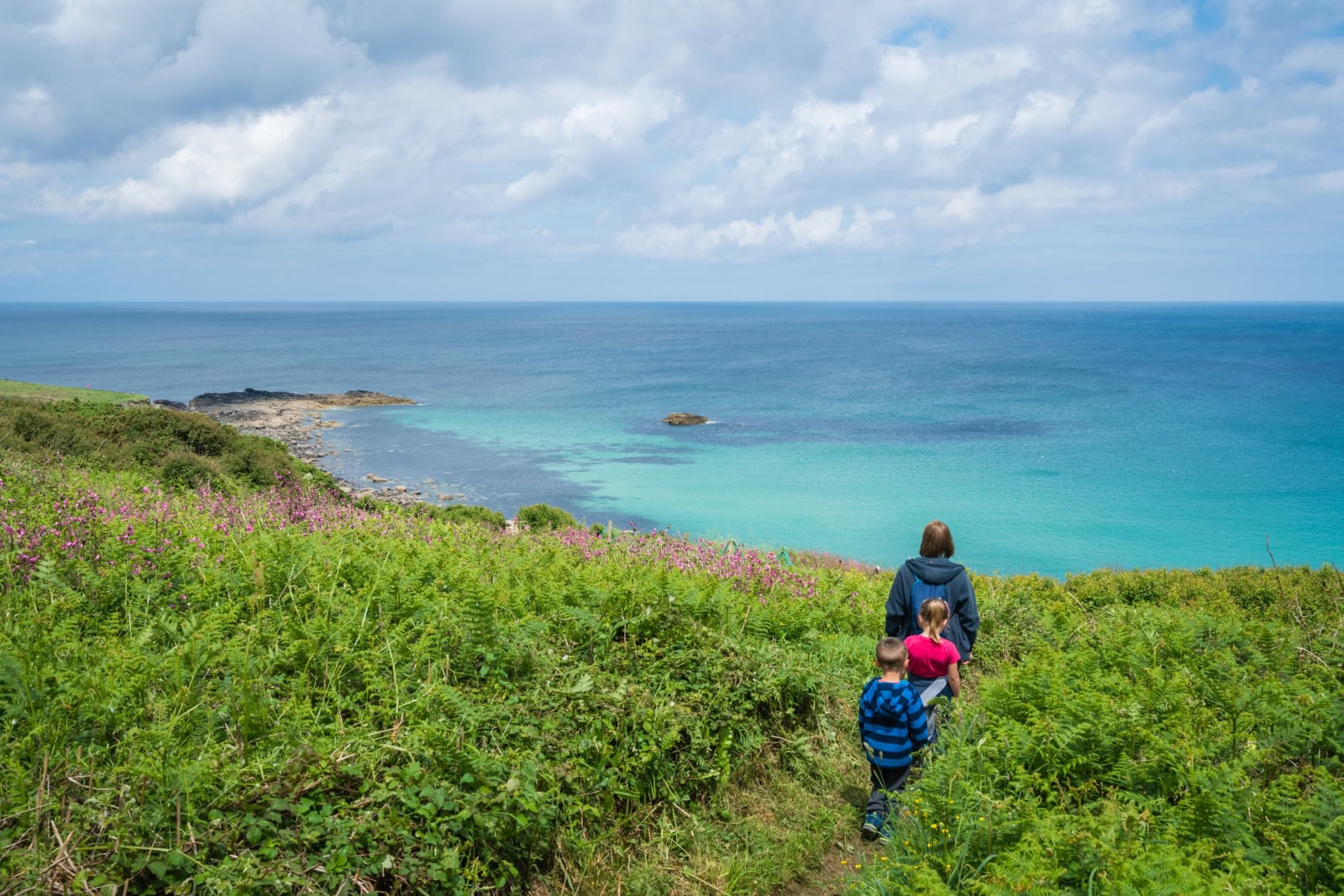 Family walking on the Cornish coast