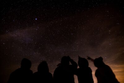 group of friends stargazing at night